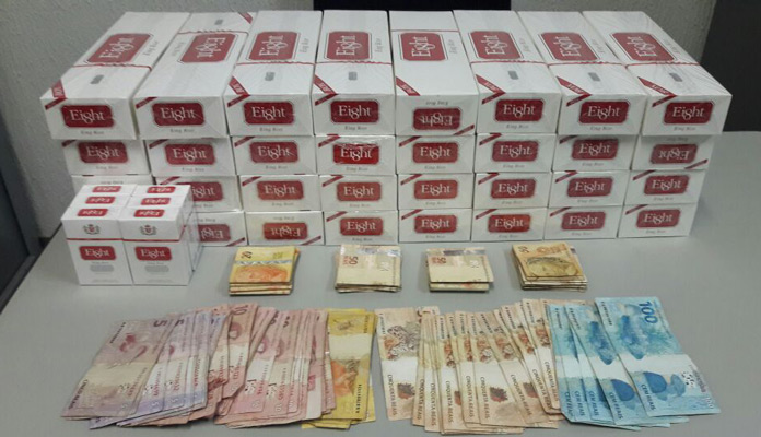 Dinheiro e cigarros apreendidos (Foto: Polícia Civil)